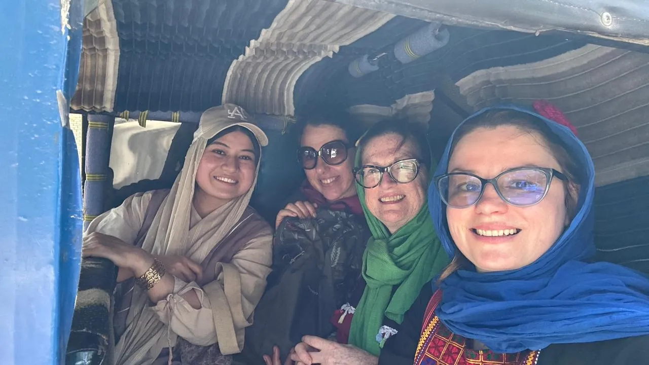 Female travelers with their local female guide experiencing a tuk tuk ride in Herat.